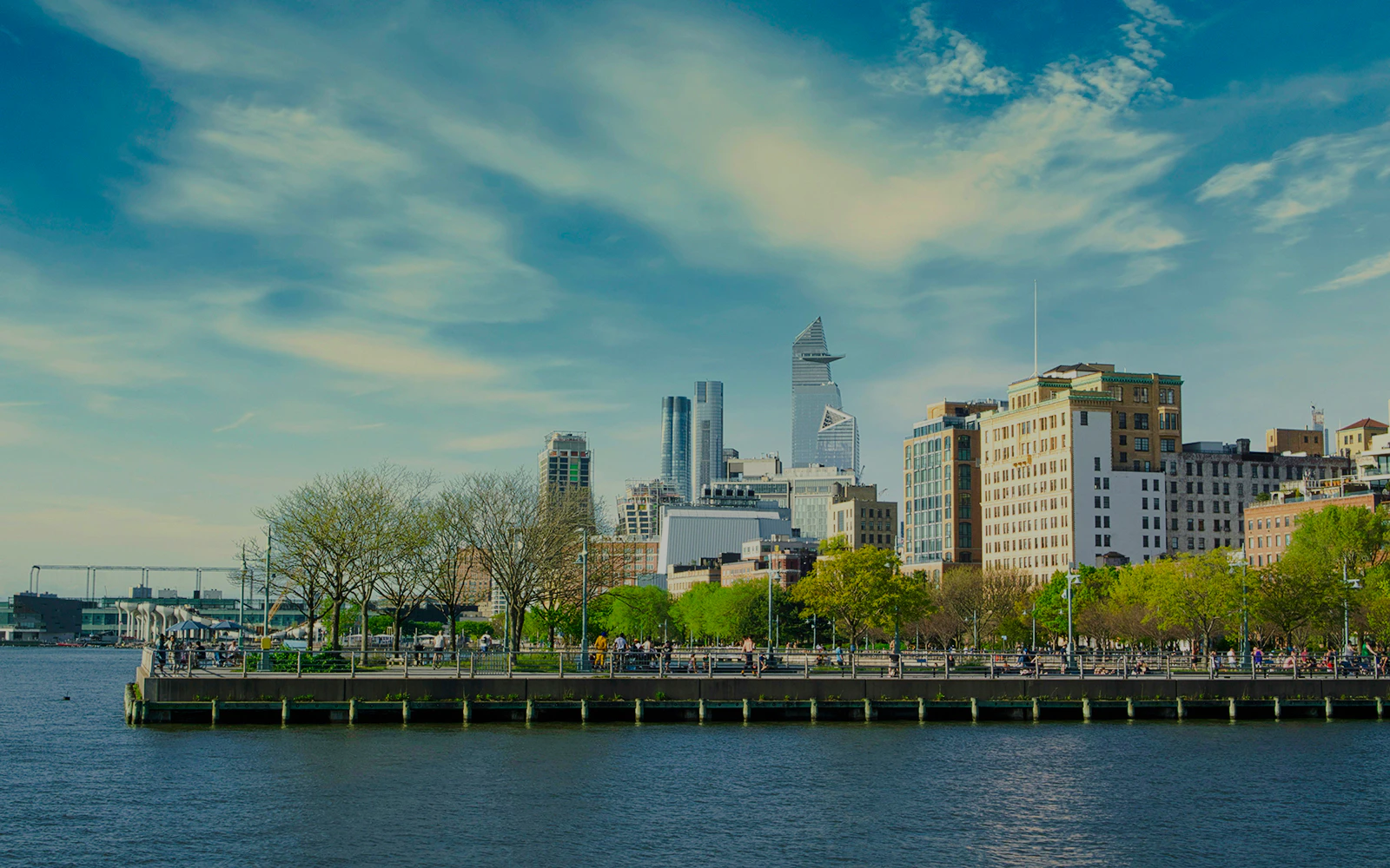 Skyline view from Pier 45 in Manhattan, NYC with Hudson River in foreground.