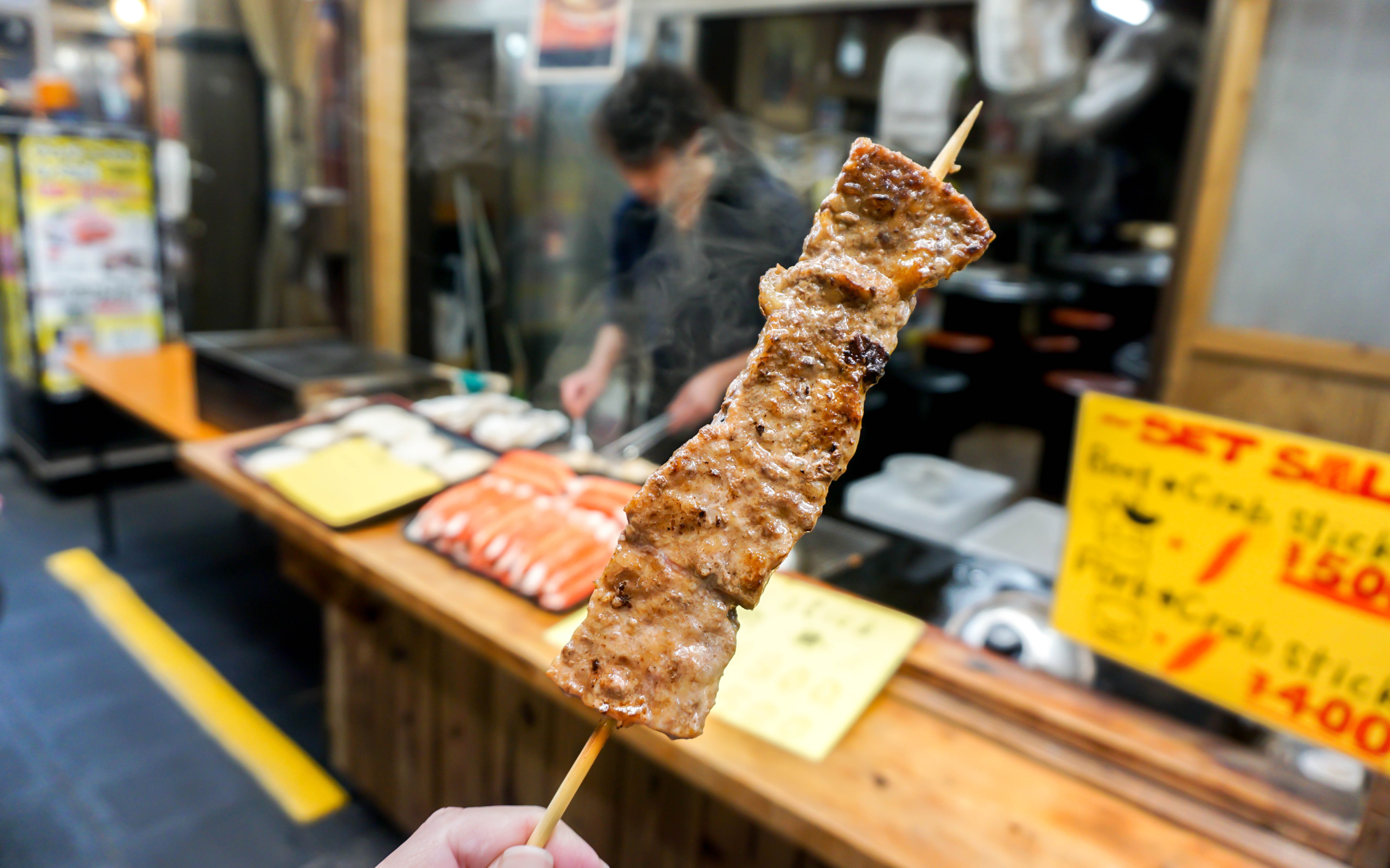 Barbecue Kobe beef skewer at a street food stall in Japan.