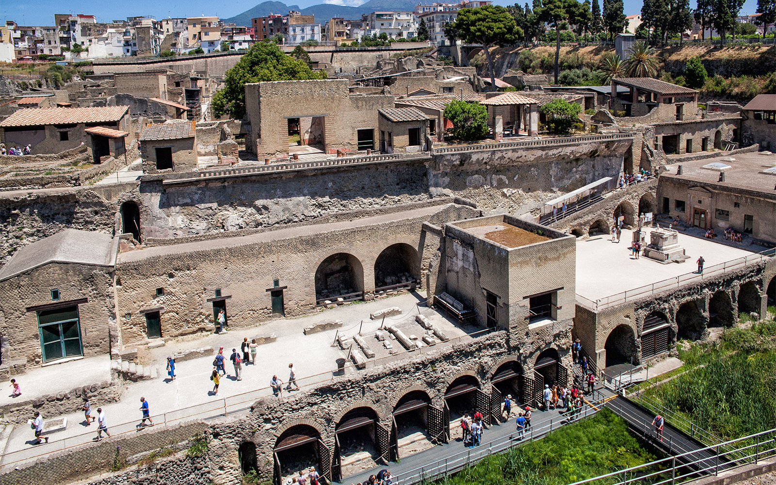 Herculaneum ruins with tourists exploring the ancient site, Italy.