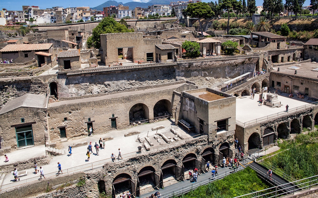 Herculaneum ruins with tourists exploring the ancient site, Italy.