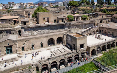 Herculaneum ruins with tourists exploring the ancient site, Italy.