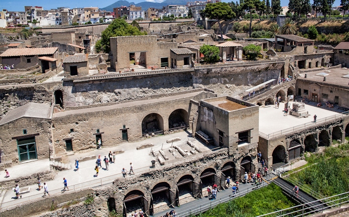 Herculaneum ruins with tourists exploring the ancient site, Italy.