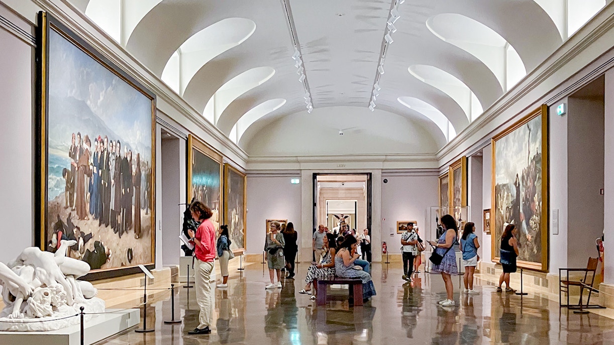 Visitors viewing artworks inside the Prado Museum, Madrid.