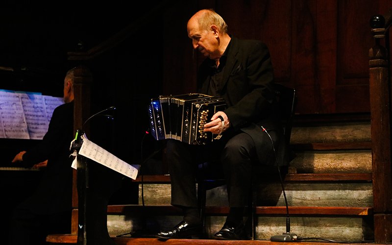 Bandoneon player performing at Aljibe Tango Show in Buenos Aires.