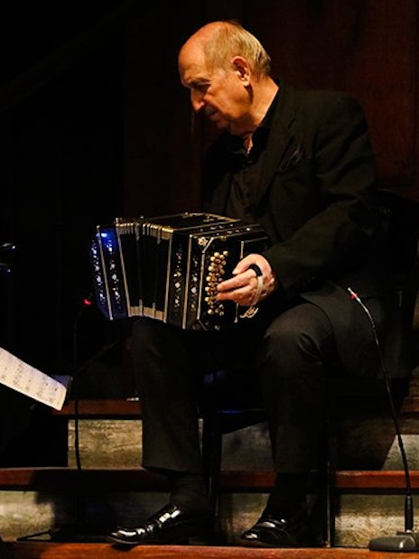 Bandoneon player performing at Aljibe Tango Show in Buenos Aires.