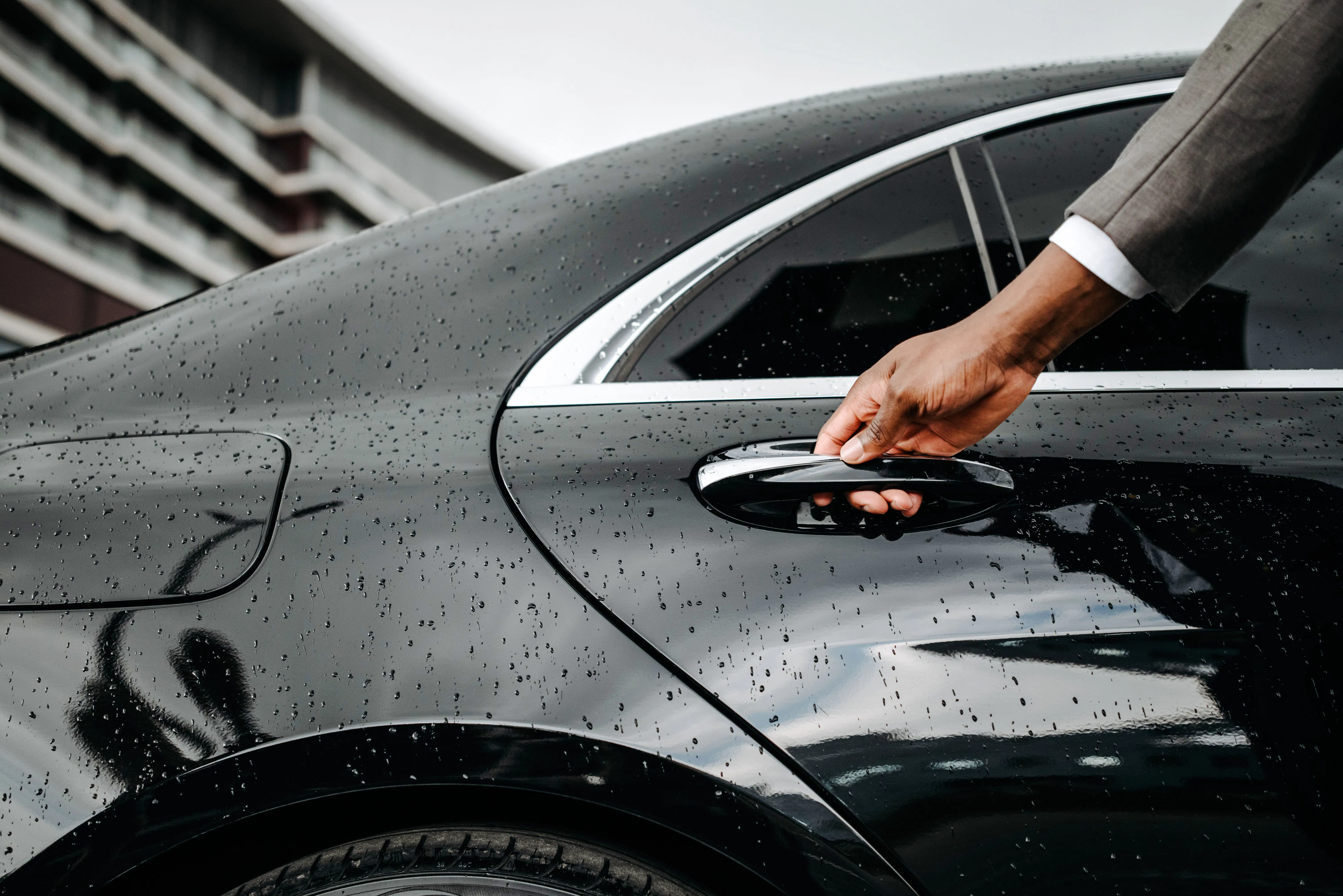 Hand opening car door for Zanzibar private transfer service.