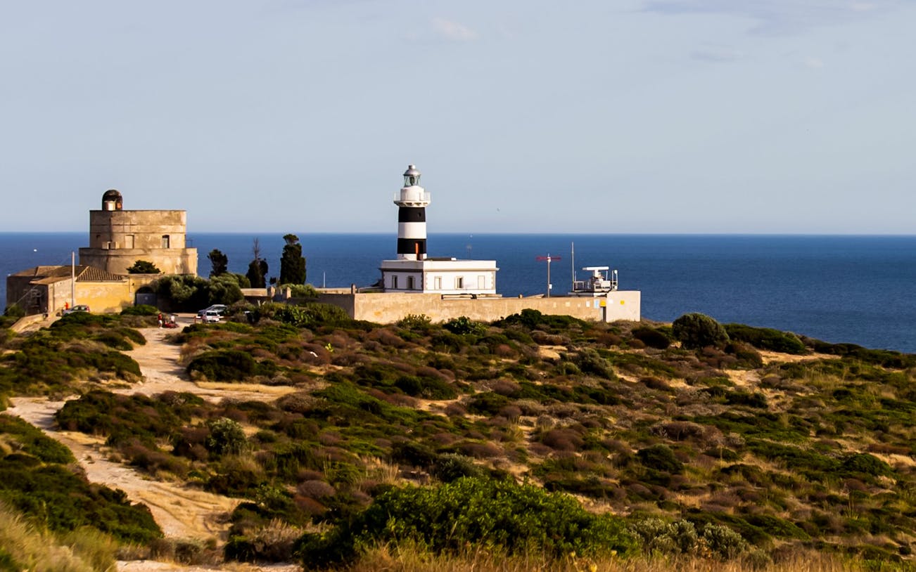 Lighthouse and tower on Colle of Sant'Elia overlooking the sea.
