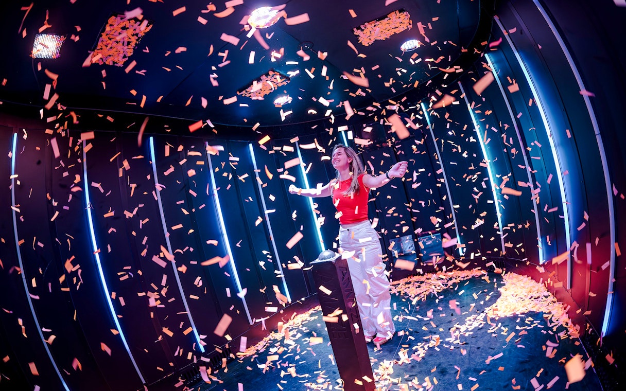 Guest enjoying confetti room at Amaze Amsterdam.