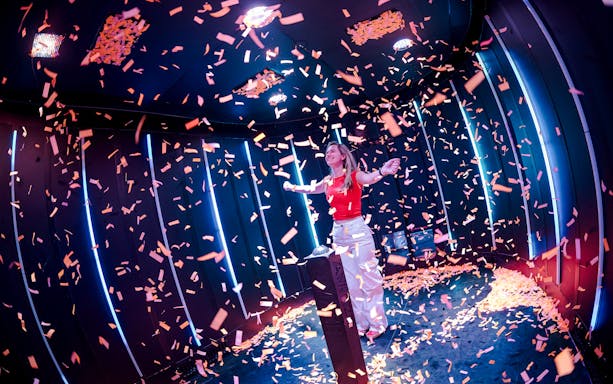 Guest enjoying confetti room at Amaze Amsterdam.