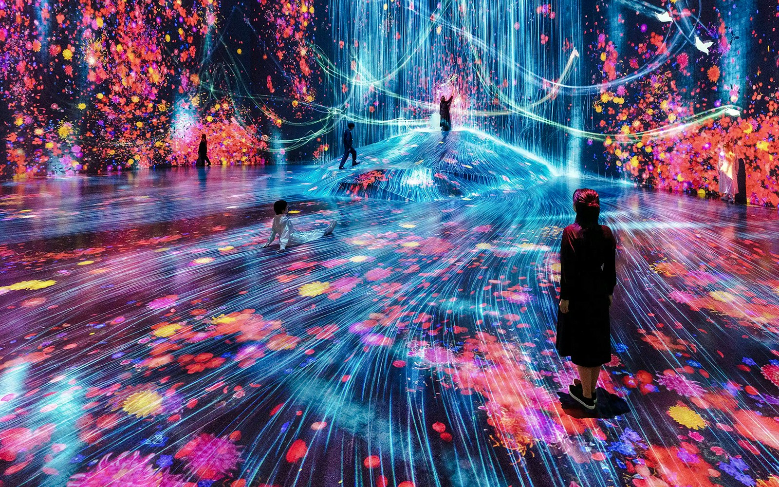 teamLabs Neon Ribbon Pathway installation in Tokyo, Japan, featuring vibrant, illuminated trails.