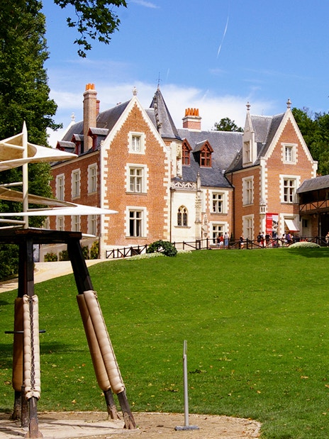 Clos Lucé Castle with spiral sculpture in garden, France.