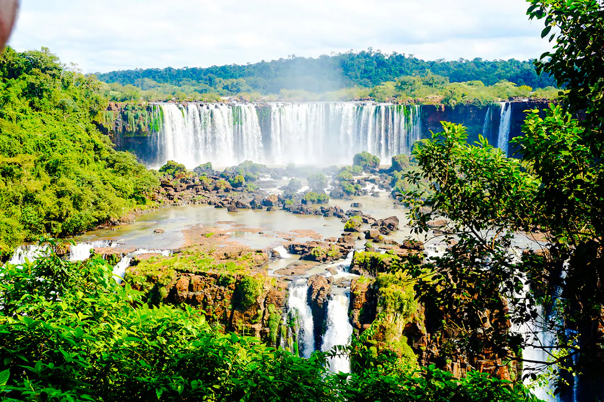 Sunrise view of Iguazu Falls with lush greenery, Foz do Iguacu, early park access tour.