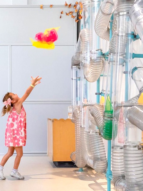 Child playing with air tubes at OliOli Children's Museum Dubai.