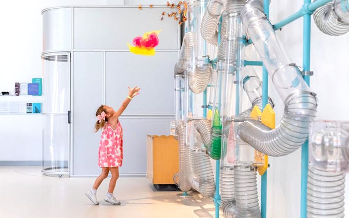 Child playing with air tubes at OliOli Children's Museum Dubai.