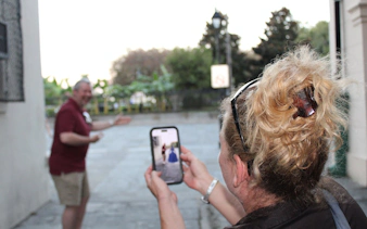 Person photographing a man during the New Orleans Interactive Ghosts and Spirits Walking Tour.