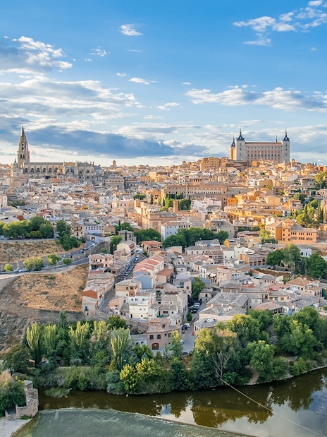 Toledo cityscape with Alcázar and Tagus River.