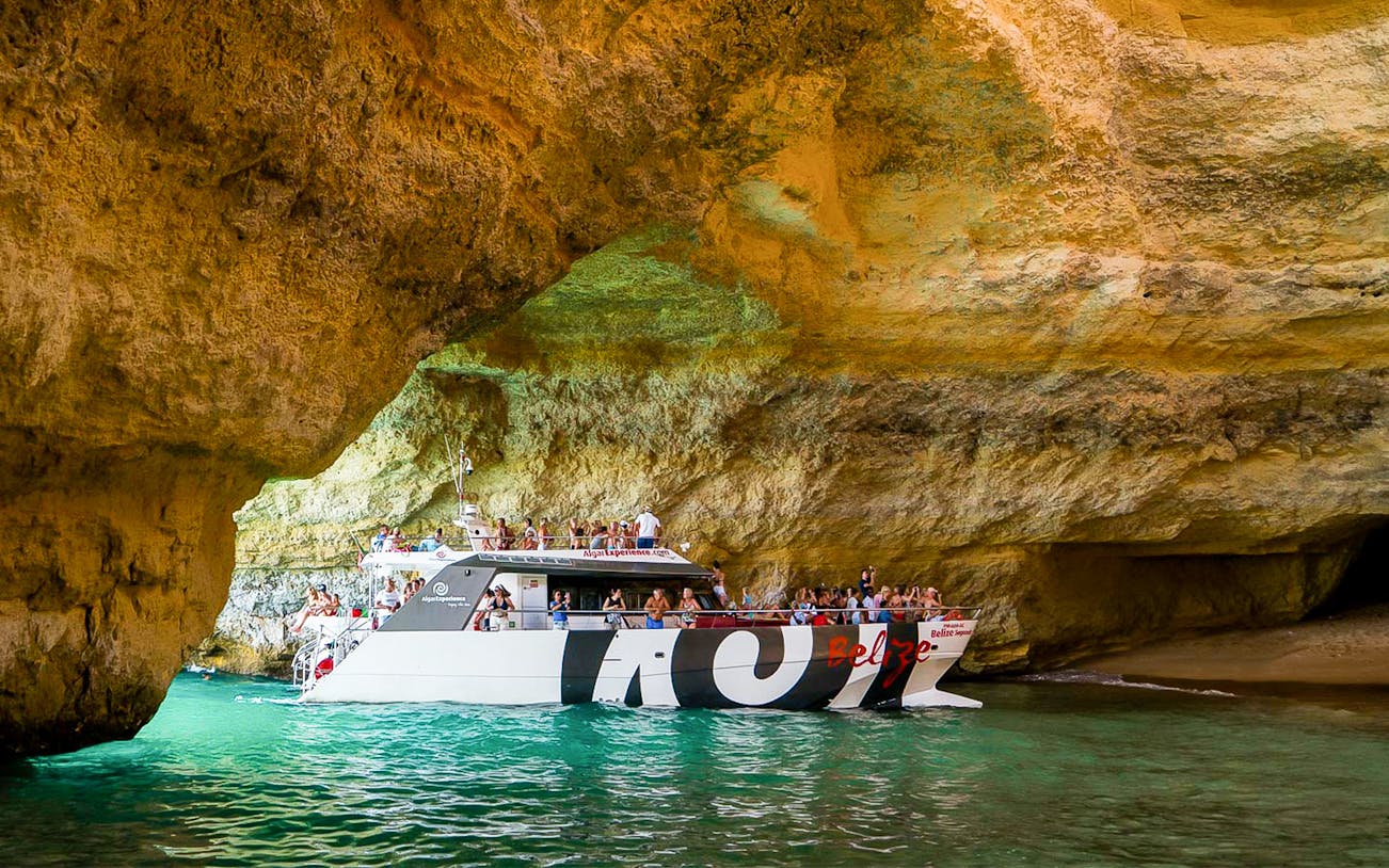 Cruise boat entering Benagil Cave on Algarve sightseeing tour from Albufeira.