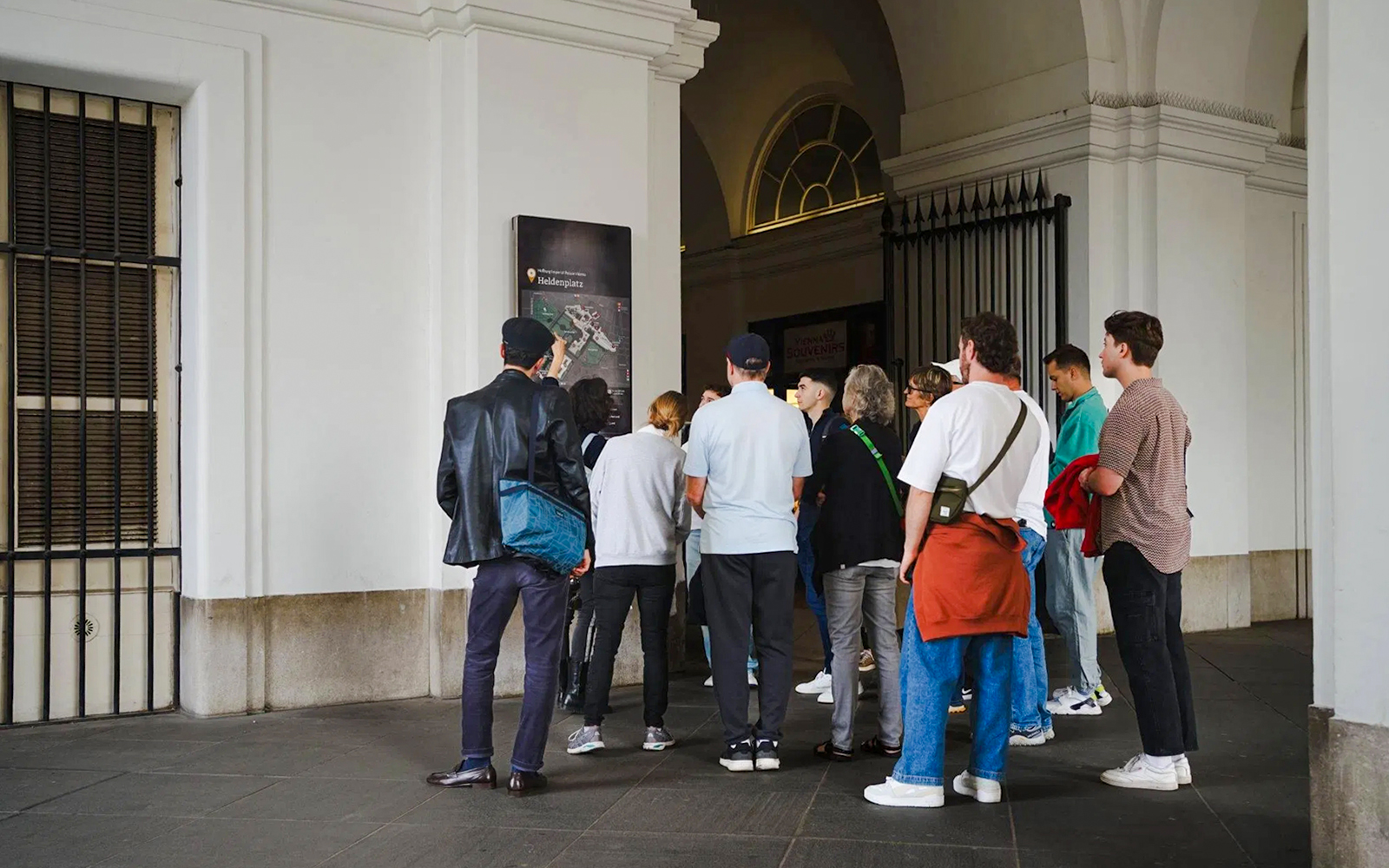 Tourists gathered at Heldenplatz during a guided walking tour in Vienna.