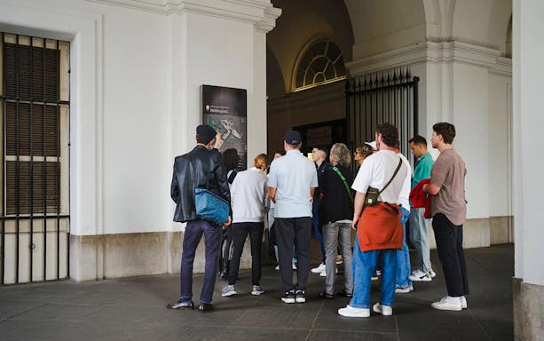 Tourists gathered at Heldenplatz during a guided walking tour in Vienna.