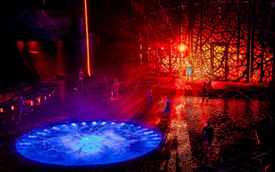 Performers on illuminated water stage at La Perle show, Dubai.