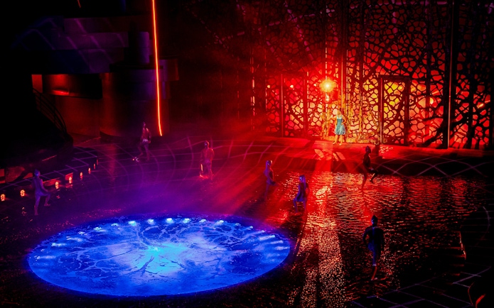 Performers on illuminated water stage at La Perle show, Dubai.