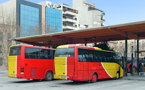 Buses parked at Ibiza station for airport transfer.