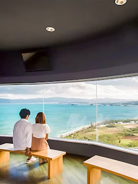 Couple enjoying ocean view from Kouri Ocean Park observatory.