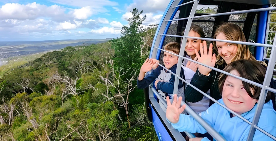 Group enjoying scenic view from Arthurs Seat Eagle gondola in Victoria, Australia.