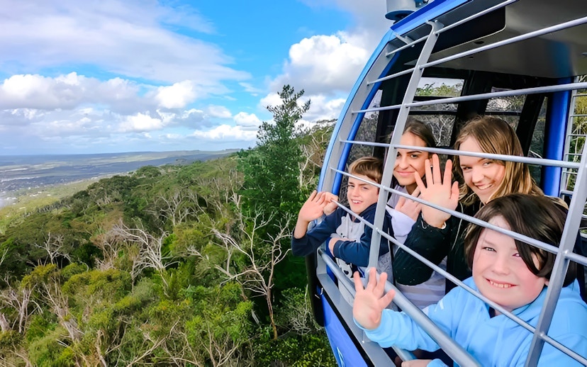 Group enjoying scenic view from Arthurs Seat Eagle gondola in Victoria, Australia.