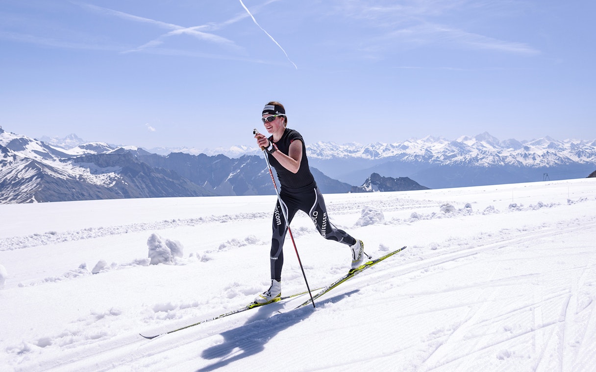 Cross-country skier on Glacier 3000 with Swiss Alps backdrop, near Montreux.