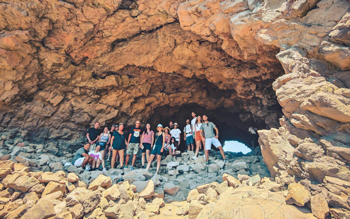 Group exploring rocky cave on Red Canyon Tour, Gran Canaria.
