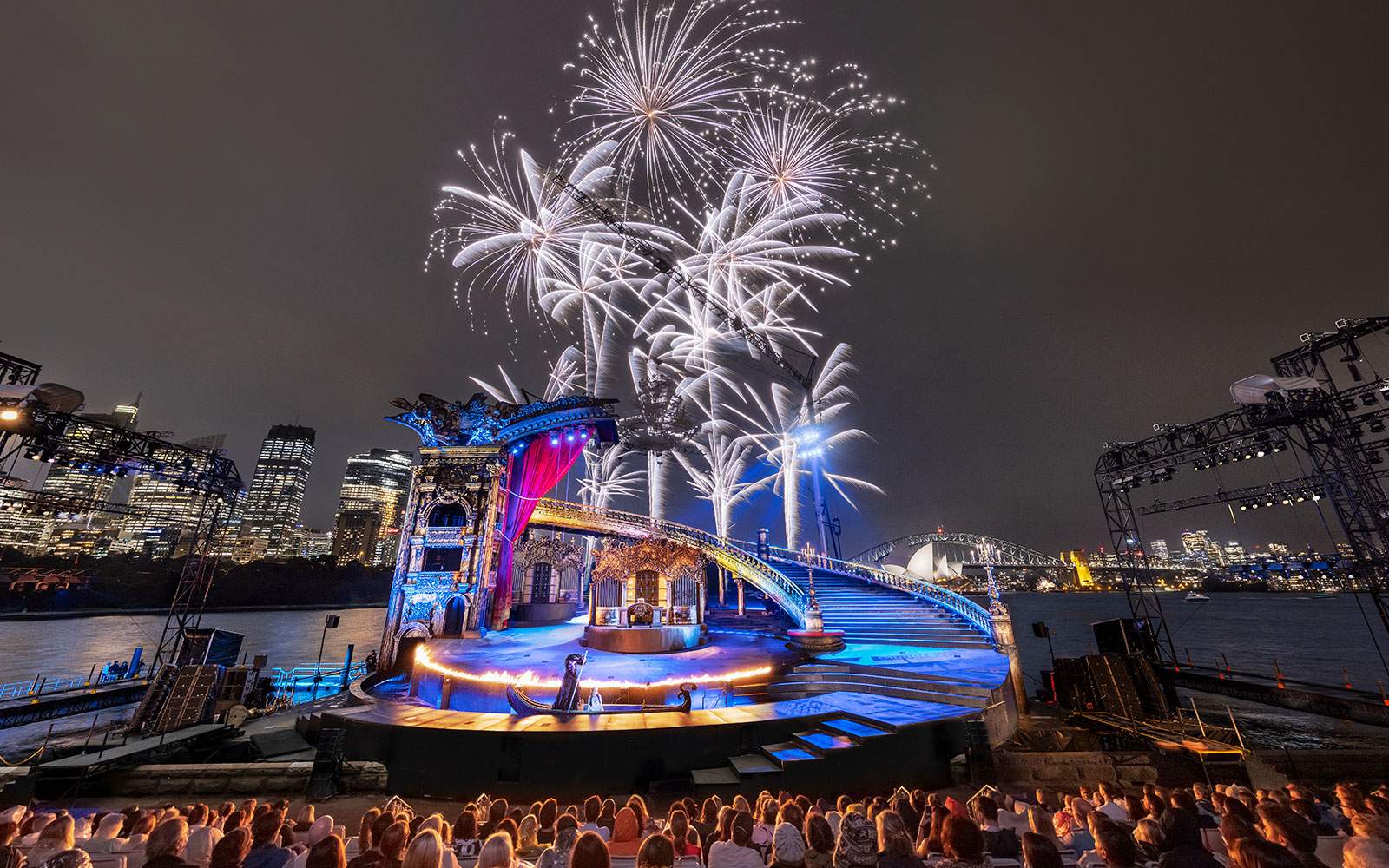 The Phantom of the Opera performance on Sydney Harbour with fireworks and city skyline.