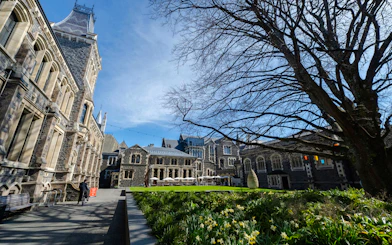 Historic stone buildings and garden on Christchurch walking tour route.