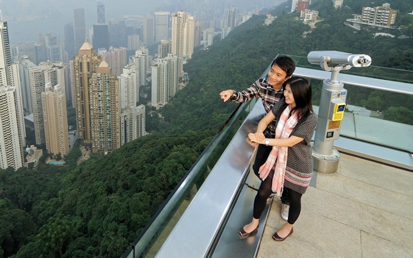 Couple enjoying Hong Kong skyline view from Sky Terrace 428 at The Peak.