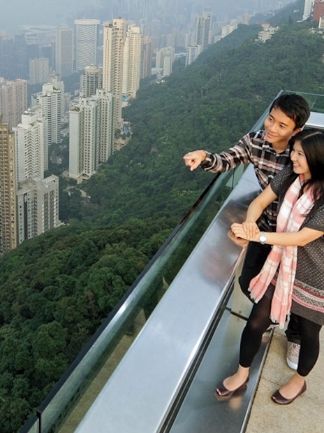Couple enjoying Hong Kong skyline view from Sky Terrace 428 at The Peak.
