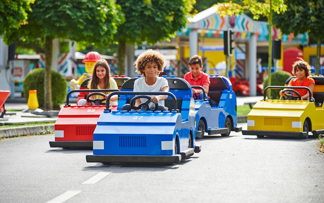 Children driving LEGO cars at LEGOLAND Windsor Resort.