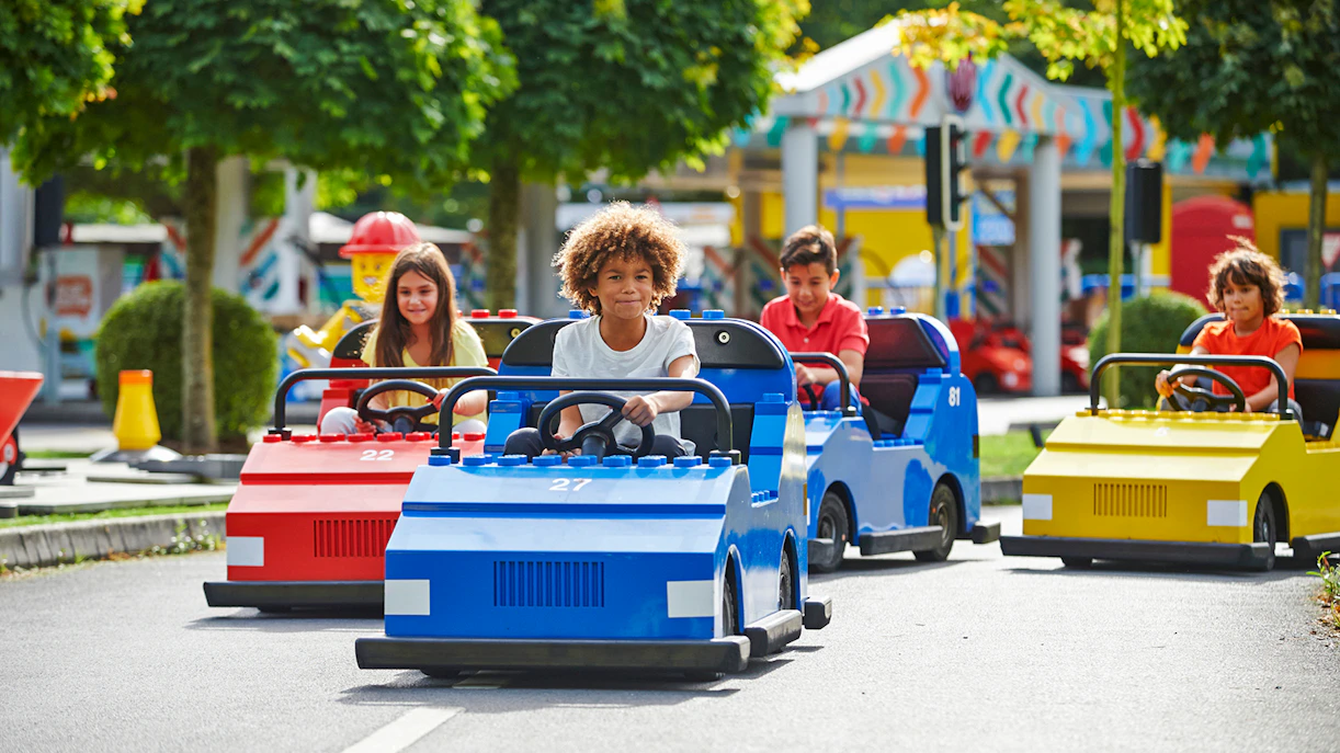 Children driving LEGO cars at LEGOLAND Windsor Resort.