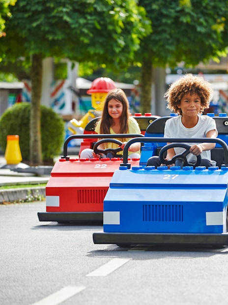 Children driving LEGO cars at LEGOLAND Windsor Resort.
