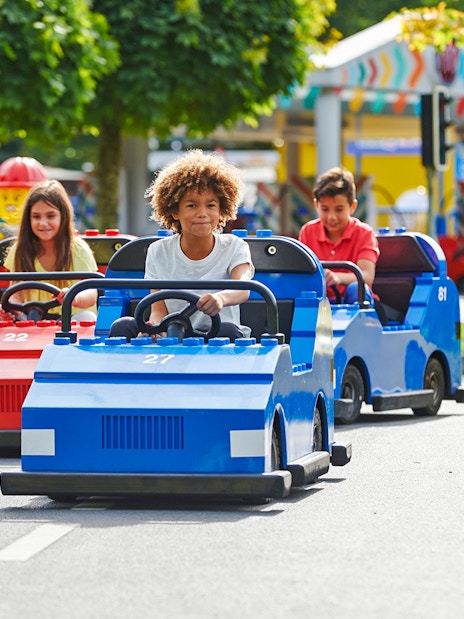 Children driving LEGO cars at LEGOLAND Windsor Resort.