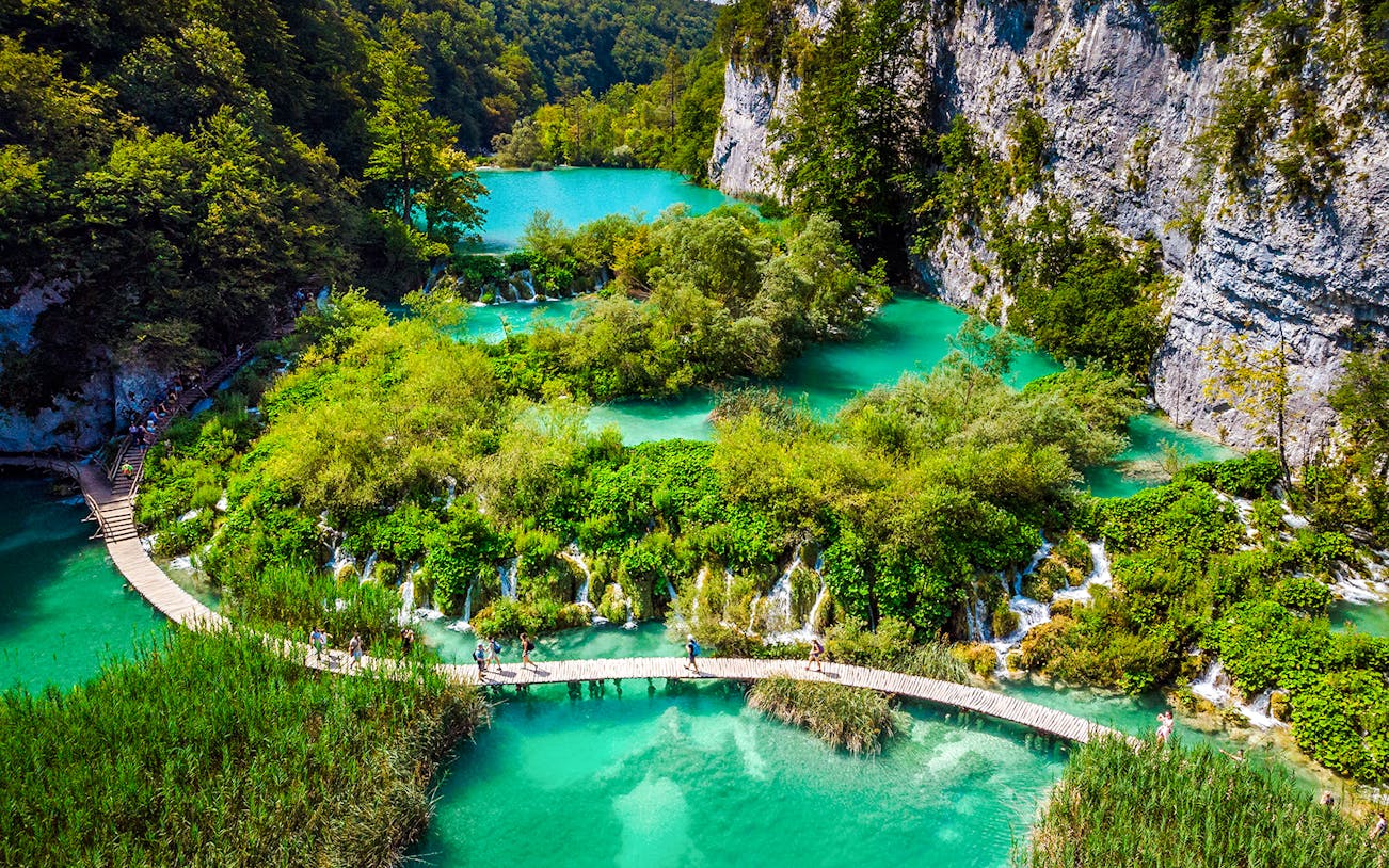 Aerial view of wooden pathways over turquoise lakes at Plitvice Lakes, Croatia.