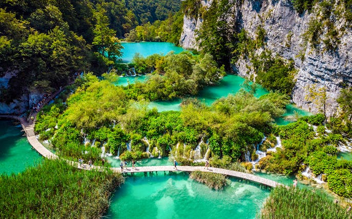 Aerial view of wooden pathways over turquoise lakes at Plitvice Lakes, Croatia.