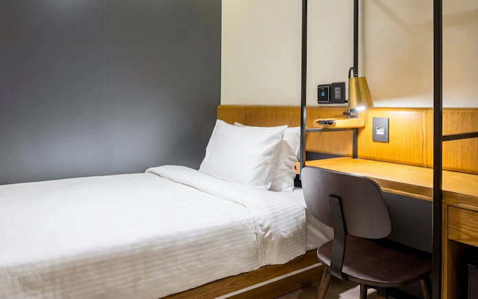Single bed and desk area at Plaza Premium Lounge, Rio de Janeiro International Airport, Arrivals T2.