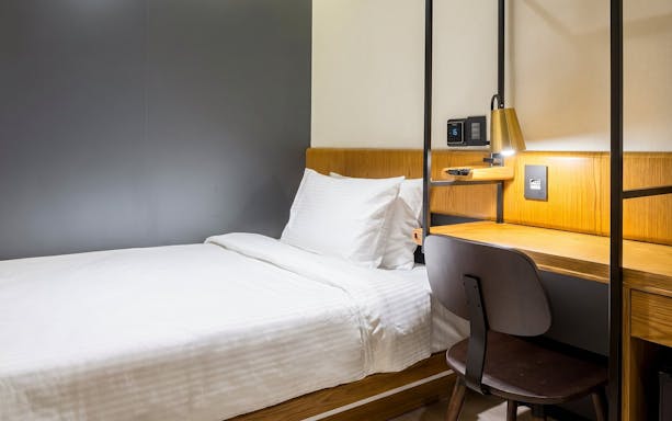 Single bed and desk area at Plaza Premium Lounge, Rio de Janeiro International Airport, Arrivals T2.