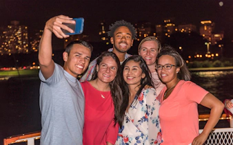Group enjoying Chicago River & Lake Sightseeing Cruise at night.
