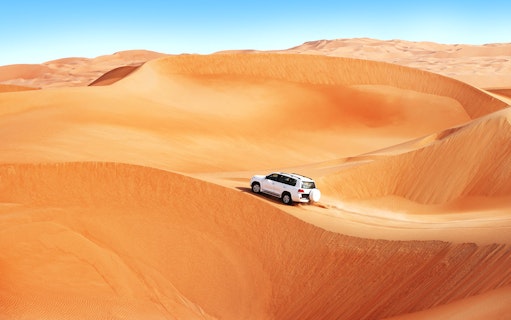 4x4 vehicle dune bashing in the Dubai desert.