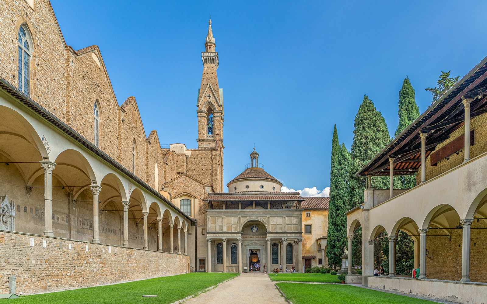 Santa Croce courtyard in Florence with bell tower and arches.