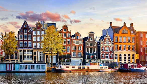 Canal houses along Amsterdam's waterfront during an evening cruise.