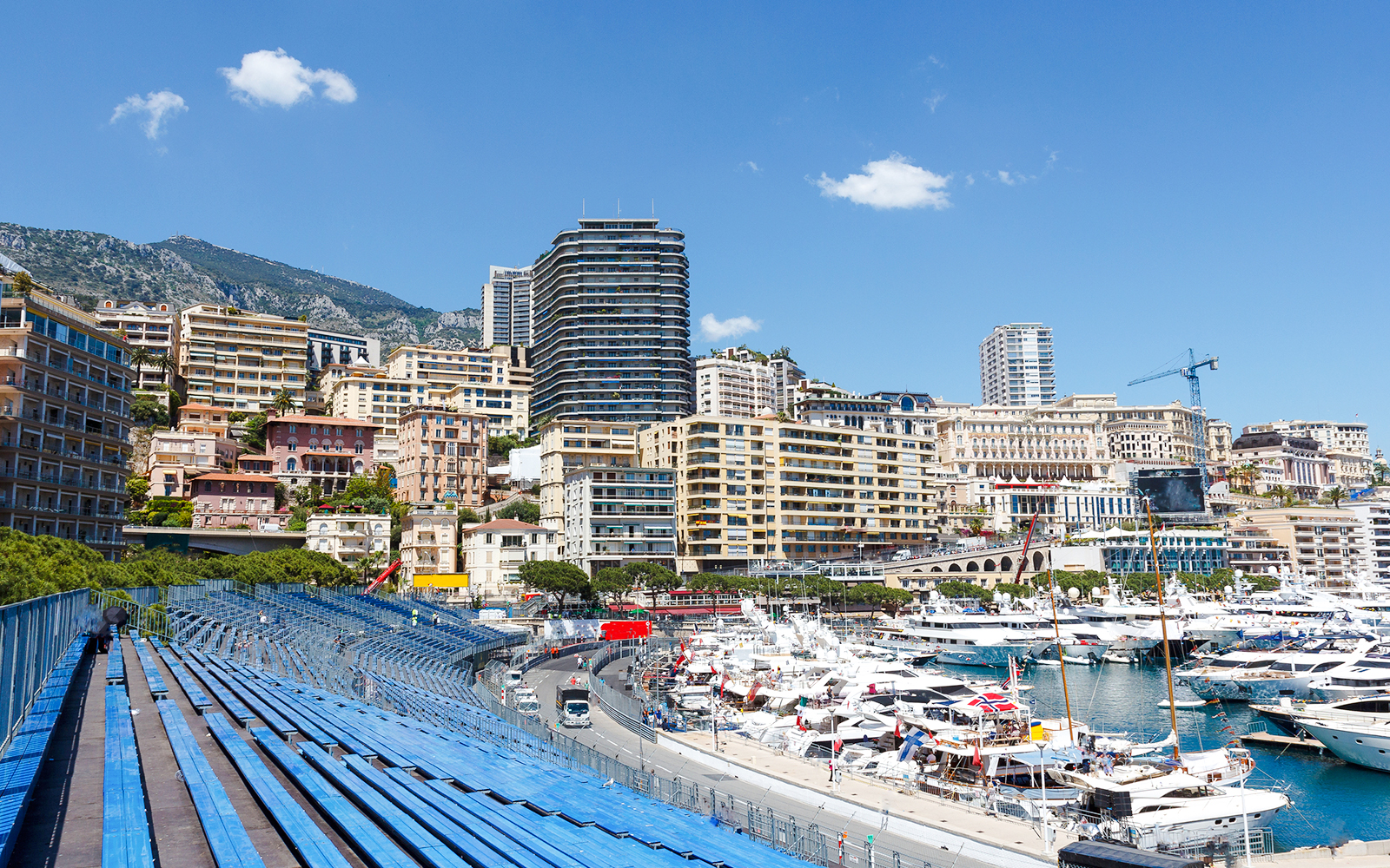 Monaco harbor with yachts and grandstands along the Formula 1 circuit.