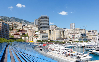 Monaco harbor with yachts and grandstands along the Formula 1 circuit.