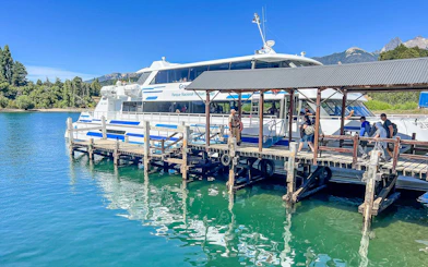 Dock at Puerto Blest with tourists boarding a boat on Nahuel Huapi Lake, Argentina.